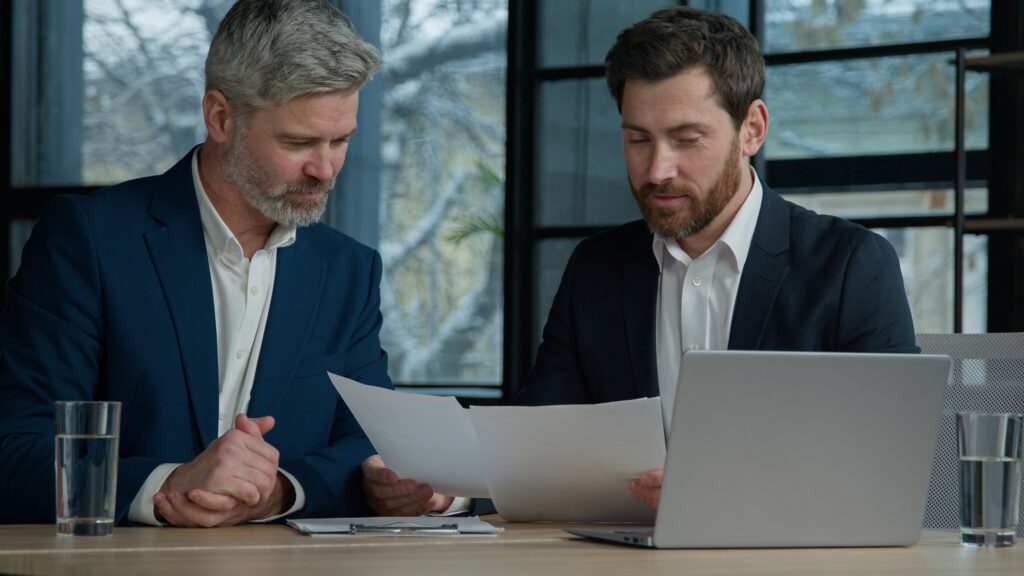 Caucasian,Men,Professional,Businessmen,Business,Partners,Coworkers,Discussing,Contract,At